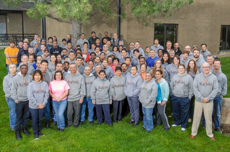 Employees gathered outside in KAHIKI® Hoodies